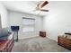 Bedroom featuring neutral walls, carpeted floors, ceiling fan, dresser and a window providing natural light at 6671 Se 108Th St, Belleview, FL 34420
