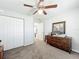 Bedroom featuring neutral walls, carpeted floors, closet and dresser, creating a comfortable space at 6671 Se 108Th St, Belleview, FL 34420