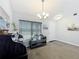 Inviting entryway with chandelier lighting, gray color scheme, and stylish decor at 6671 Se 108Th St, Belleview, FL 34420