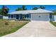 Attractive home boasting a well-maintained lawn, attached garage and an American flag, making it a perfect Gathering home at 6671 Se 108Th St, Belleview, FL 34420