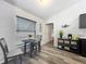 Eat-in kitchen featuring a small table, decor and light-colored wood-look floors, creating a cozy dining space at 6671 Se 108Th St, Belleview, FL 34420