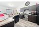 This modern kitchen features stainless steel appliances, dark cabinetry and a double sink at 6671 Se 108Th St, Belleview, FL 34420