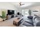 This living room features a ceiling fan, neutral walls and a comfortable sitting area at 6671 Se 108Th St, Belleview, FL 34420