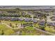 Community aerial view, featuring the golf course, palm trees, and a neighborhood of well-maintained homes at 7503 Sw 97Th Terrace Rd, Ocala, FL 34481