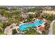 An aerial view of a resort-style community pool complete with palm trees, lounge chairs, and shady cabanas at 7503 Sw 97Th Terrace Rd, Ocala, FL 34481