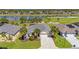 Beautiful home with a paver driveway, lush landscaping and picturesque views of the lake and golf course at 7503 Sw 97Th Terrace Rd, Ocala, FL 34481