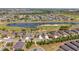 Aerial view of single-Gathering homes in a community featuring a golf course with ponds and lush landscaping at 7503 Sw 97Th Terrace Rd, Ocala, FL 34481