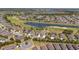 Aerial view of single-Gathering homes in a community featuring a golf course with ponds and lush landscaping at 7503 Sw 97Th Terrace Rd, Ocala, FL 34481
