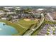 Aerial view of community baseball field, tennis courts, clubhouse, and residential homes at 7503 Sw 97Th Terrace Rd, Ocala, FL 34481