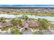 Aerial view of community clubhouse featuring lake, golf course, mature trees and lush landscaping at 7503 Sw 97Th Terrace Rd, Ocala, FL 34481