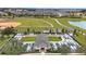 Community garden plots with adjacent baseball field, golf carts, and a walking path at 7503 Sw 97Th Terrace Rd, Ocala, FL 34481