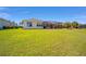 Spacious backyard with a well-maintained lawn, leading up to a screened-in patio for outdoor enjoyment at 7503 Sw 97Th Terrace Rd, Ocala, FL 34481