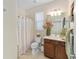 Bathroom with a shower-tub combination, vanity with dark wood cabinets, and decorative accents at 7503 Sw 97Th Terrace Rd, Ocala, FL 34481