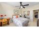 Bedroom features a wicker headboard, floral bedding, a workstation, and a mirrored closet reflecting the room at 7503 Sw 97Th Terrace Rd, Ocala, FL 34481