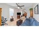 Bonus room with blue leather sofa, mirrored closet, ceiling fan and a large window for natural light at 7503 Sw 97Th Terrace Rd, Ocala, FL 34481