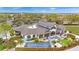 Exterior angle of the clubhouse with outdoor dining and a manicured landscape at 7503 Sw 97Th Terrace Rd, Ocala, FL 34481