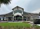 Angle view of the clubhouse showing the lawn games and outdoor seating area at 7503 Sw 97Th Terrace Rd, Ocala, FL 34481
