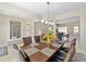 An open concept dining room features a decorative light fixture and access to other rooms at 7503 Sw 97Th Terrace Rd, Ocala, FL 34481