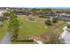 Expansive community dog park with green grass, play structures, and shaded pavilion, offering a great space for pet owners at 7503 Sw 97Th Terrace Rd, Ocala, FL 34481