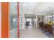 Inviting foyer leads to open floorplan and showcases tile floors and glass shelving at 7503 Sw 97Th Terrace Rd, Ocala, FL 34481