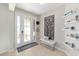 Bright foyer featuring tiled floors, a bench, and decorative shelving at 7503 Sw 97Th Terrace Rd, Ocala, FL 34481