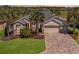 Well maintained home with a 3-car garage, paver driveway, mature landscaping, and beautiful curb appeal at 7503 Sw 97Th Terrace Rd, Ocala, FL 34481