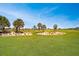 Scenic golf course view featuring lush green grass, sand traps, and palm trees on a bright day at 7503 Sw 97Th Terrace Rd, Ocala, FL 34481