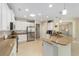 Bright open concept kitchen with stainless steel appliances, breakfast bar, and tile flooring at 7503 Sw 97Th Terrace Rd, Ocala, FL 34481