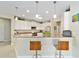 Bright kitchen area with white cabinetry, stainless appliances and a breakfast bar with stylish seating at 7503 Sw 97Th Terrace Rd, Ocala, FL 34481