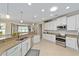 Kitchen view showing granite counters, stainless appliances and an open floorplan to the living area at 7503 Sw 97Th Terrace Rd, Ocala, FL 34481