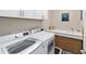 Functional laundry room features a side-by-side washer and dryer with plenty of cabinet and counter space at 7503 Sw 97Th Terrace Rd, Ocala, FL 34481