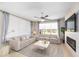The living room has neutral colors, modern decor, tile flooring, and lots of natural light at 7503 Sw 97Th Terrace Rd, Ocala, FL 34481