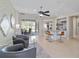 Open-concept living room offers sliding glass doors to screened porch and bar seating for entertaining at 7503 Sw 97Th Terrace Rd, Ocala, FL 34481