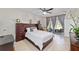 Relaxing primary bedroom with large bed, dark wood furniture, and sliding glass doors to the outdoor patio at 7503 Sw 97Th Terrace Rd, Ocala, FL 34481