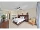 Bright and airy main bedroom with comfortable seating area, neutral decor, and large window views at 7503 Sw 97Th Terrace Rd, Ocala, FL 34481