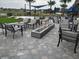 Outdoor seating area features a modern fire pit and a variety of comfortable chairs at 7503 Sw 97Th Terrace Rd, Ocala, FL 34481