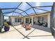 Beautiful screened-in patio with hot tub, ceiling fan, and plenty of space for seating and entertaining at 7503 Sw 97Th Terrace Rd, Ocala, FL 34481