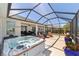 Back patio with a hot tub, outdoor seating, and views of the surrounding greenery at 7503 Sw 97Th Terrace Rd, Ocala, FL 34481