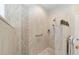 The shower features beige-toned tilework with a decorative tile accent and a dual shower head system at 7503 Sw 97Th Terrace Rd, Ocala, FL 34481