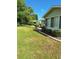 Landscaped backyard featuring well-manicured lawn and decorative border with shrubs at 8107 Sw 108Th Place Rd, Ocala, FL 34481