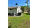 Home exterior featuring landscaped lawn and neatly trimmed shrubbery at 8107 Sw 108Th Place Rd, Ocala, FL 34481