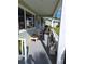 Cozy front porch with neutral paint, bright sunlight, and cute decor at 8107 Sw 108Th Place Rd, Ocala, FL 34481