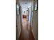 Clean hallway that connects living spaces with natural light and wood flooring at 8107 Sw 108Th Place Rd, Ocala, FL 34481