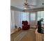 Bright living room featuring a comfortable chair, ceiling fan and window blinds at 8107 Sw 108Th Place Rd, Ocala, FL 34481
