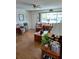 Inviting living room featuring wood floors, lots of natural light, and cozy furnishings at 8107 Sw 108Th Place Rd, Ocala, FL 34481