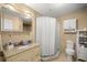The well-maintained bathroom features neutral tile and a shower with a curtain at 8215 Sw 53Rd Ct, Ocala, FL 34476