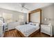 Bright bedroom with wood flooring, dresser, and a comfortable bed at 8215 Sw 53Rd Ct, Ocala, FL 34476