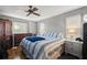 Comfortable bedroom with hardwood floors, a ceiling fan, and natural light at 8215 Sw 53Rd Ct, Ocala, FL 34476