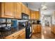 Well-lit kitchen with wooden cabinets, black appliances, and granite countertops at 8215 Sw 53Rd Ct, Ocala, FL 34476