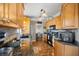 Well-lit kitchen featuring granite countertops, stainless steel appliances, and wood cabinets at 8215 Sw 53Rd Ct, Ocala, FL 34476
